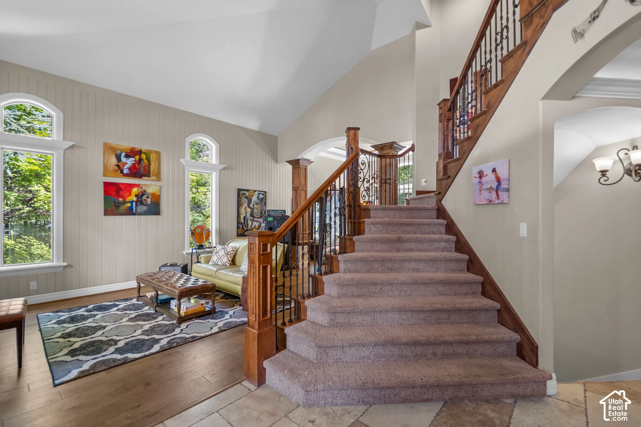 Grand foyer with beautiful wood handrails and decorative wrought iron balusters. The two story high space is just one of many WOW moments this home offers.