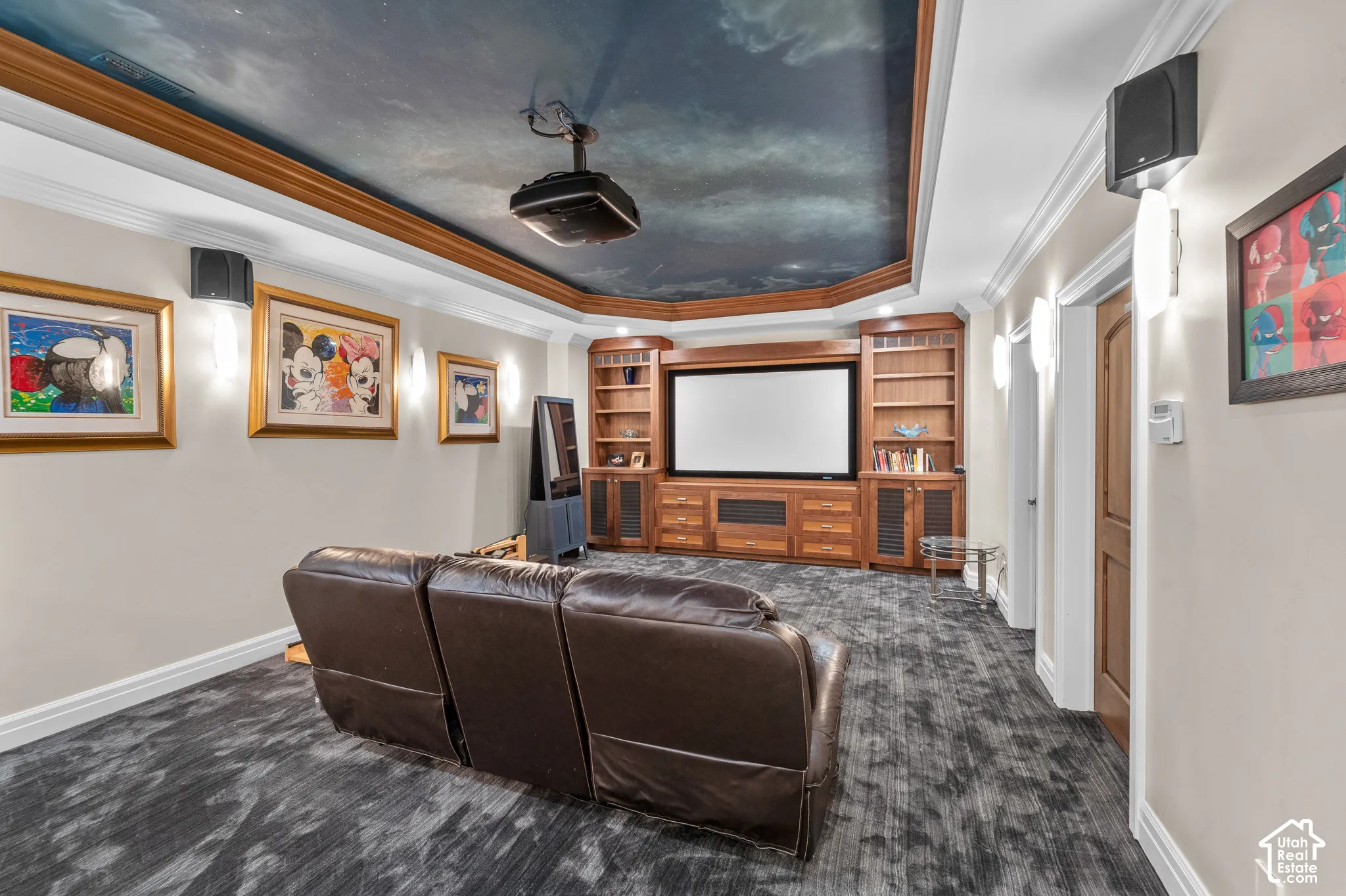 Built-in entertainment center with custom  shelving, ceiling-mounted projector, wall-mounted speakers, and decorative hand painted ceiling. There is also media closet to keep all your equipment tidy and out of view.