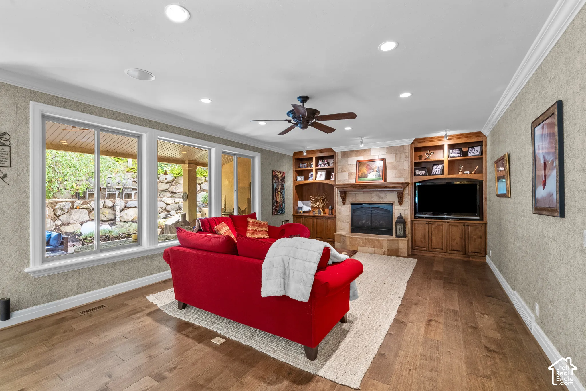 Beautiful hardwood flooring, crown molding, recessed lighting, built-in cabinetry, and a stone-clad fireplace add to the charm of this home.