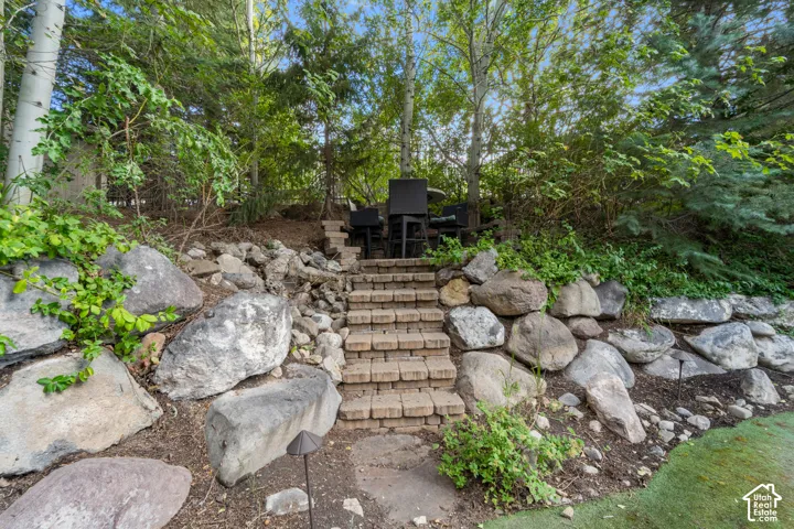 There are stone steps and paths all over the yard each leading to a reading nook or seating area, small trail or putting green. So much adventure awaits you here.