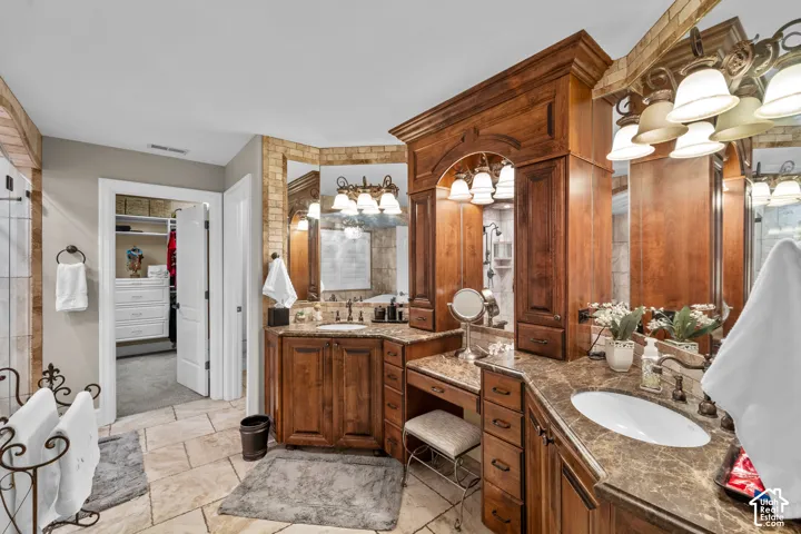 Dual vanity with beautiful cabinetry, integrated sinks, and plenty of space to get ready for your day.