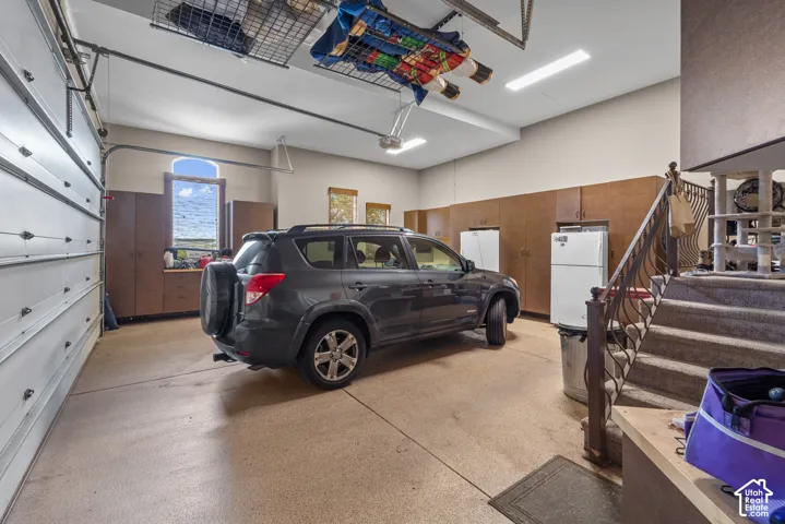 The attached four car garage is divided into two sides. Both with plenty of storage and room to park.