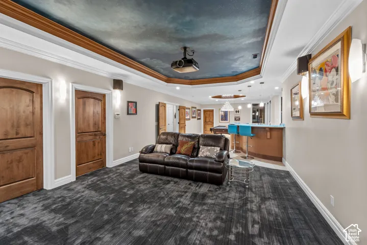 Custom-painted ceiling with recessed lighting and wood trim. From this view you can see the built-in bar all the way back to the pool table.