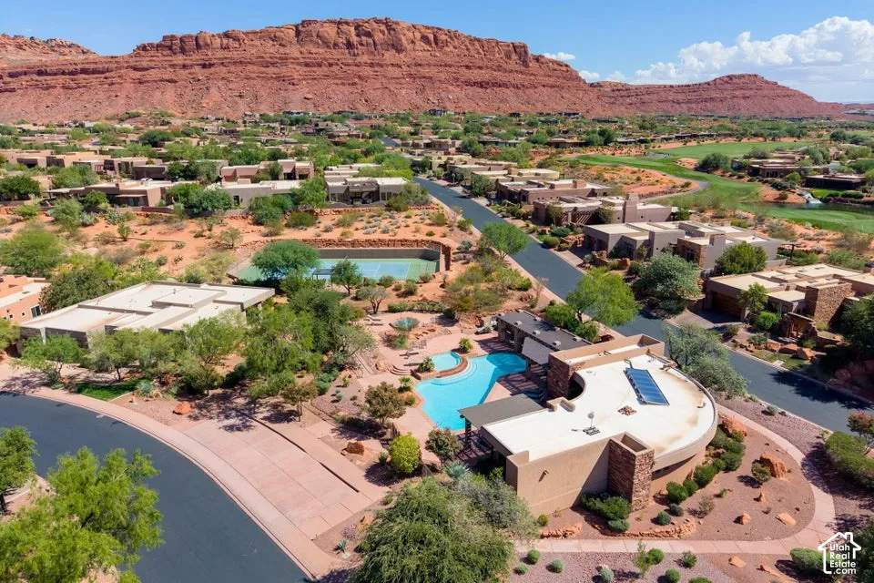 Expansive resort-style grounds featuring a swimming pool, tennis court, and golf course