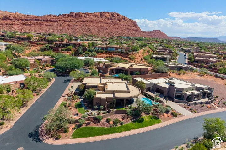 Modern desert architecture with flat roofs, integrated swimming pool, and mature landscaping