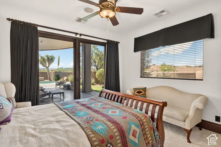Sliding glass doors opening to an exterior patio, complemented by a window with horizontal blinds and an overhead valance