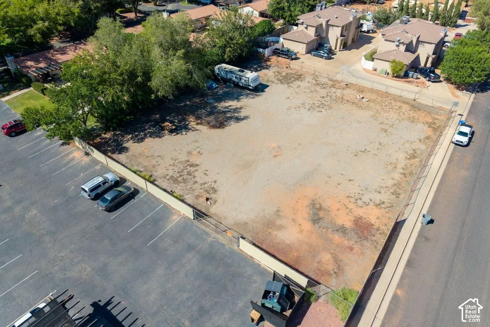 Expansive lot with a gravel surface, surrounded by fencing