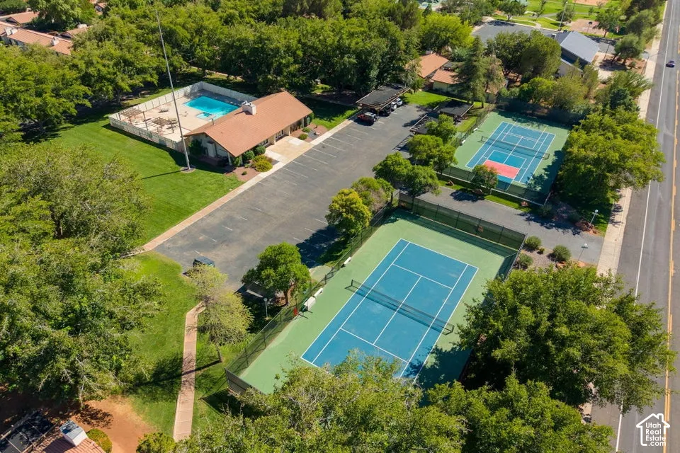 Community recreation area featuring a swimming pool, two tennis courts, and a parking lot