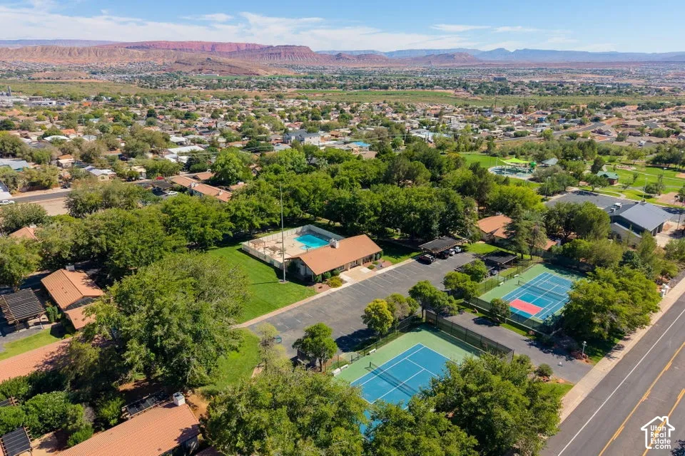Community amenities featuring a swimming pool, two tennis courts, and mature trees