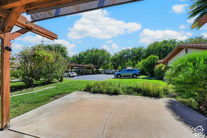 Concrete patio area with a wood pergola structure