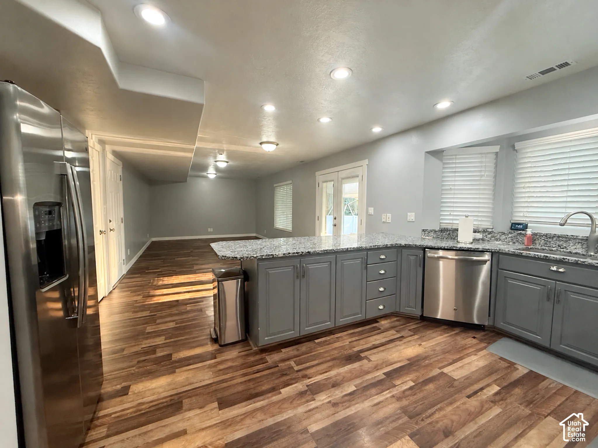 Kitchen - Family Room: Open-concept living space with wood-finish flooring -