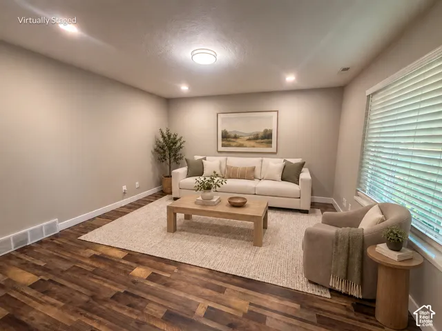 Recessed lighting, wood-finish flooring, light-colored walls, and a window with blinds