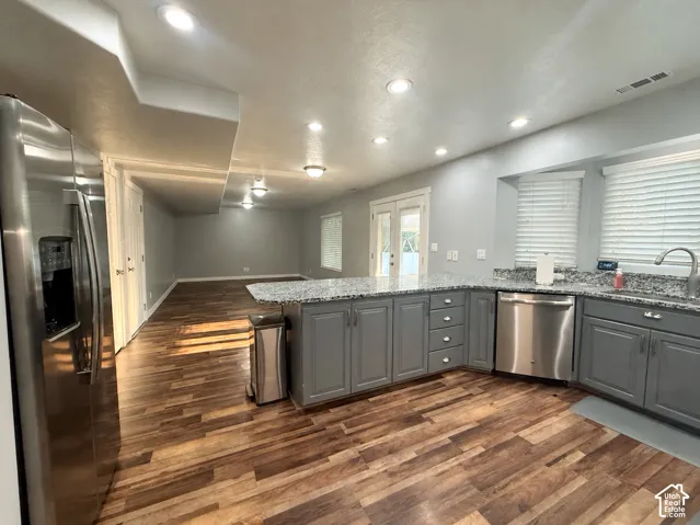 Kitchen - Family Room: Open-concept living space with wood-finish flooring -