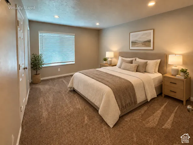 Carpeted flooring, recessed ceiling lighting, a window with blinds, and a built-in closet with panel doors