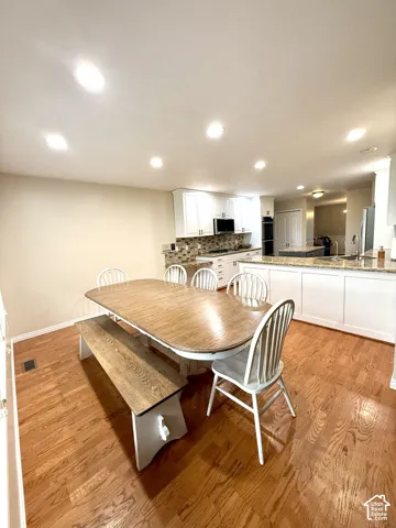 Recessed lighting illuminates the dining area and kitchen