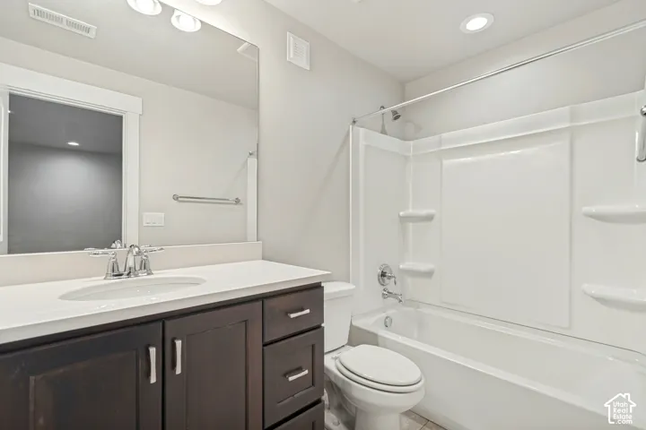 Vanity with integrated sink, dark wood-finish cabinetry, and chrome fixtures