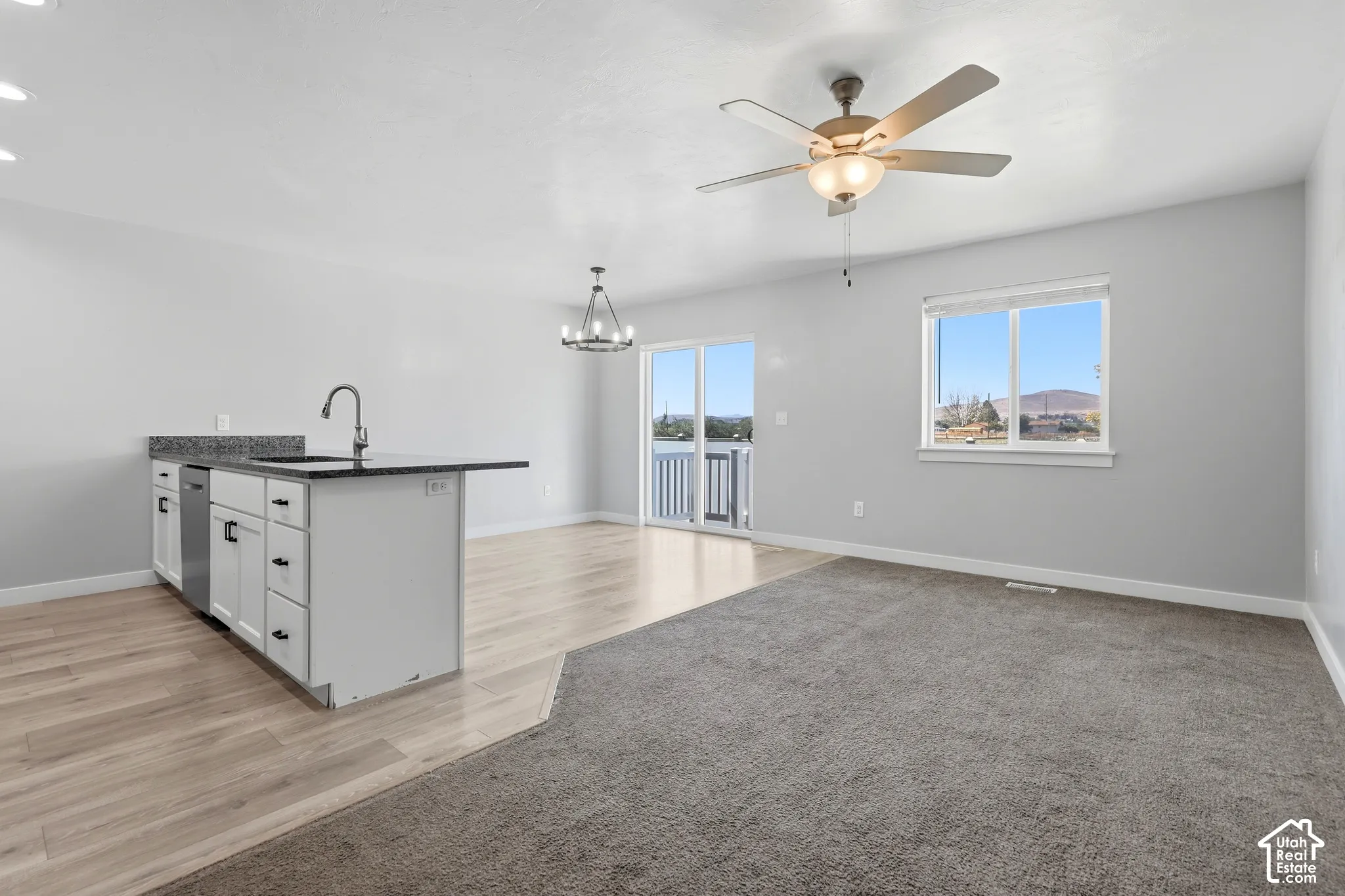 Kitchen island with an undermount sink and dark countertop