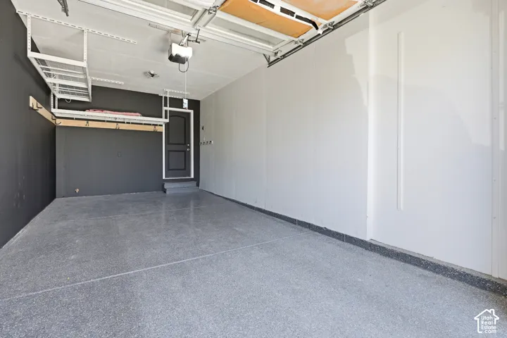 Epoxy-coated flooring, overhead storage racks, garage door opener, and interior access door