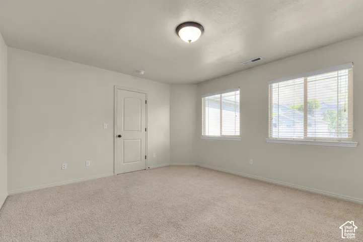 Primary Bedroom-Neutral-toned walls and carpeted flooring