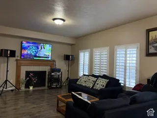 Living area featuring a fireplace with a wood mantle, tile surround, and a hearth