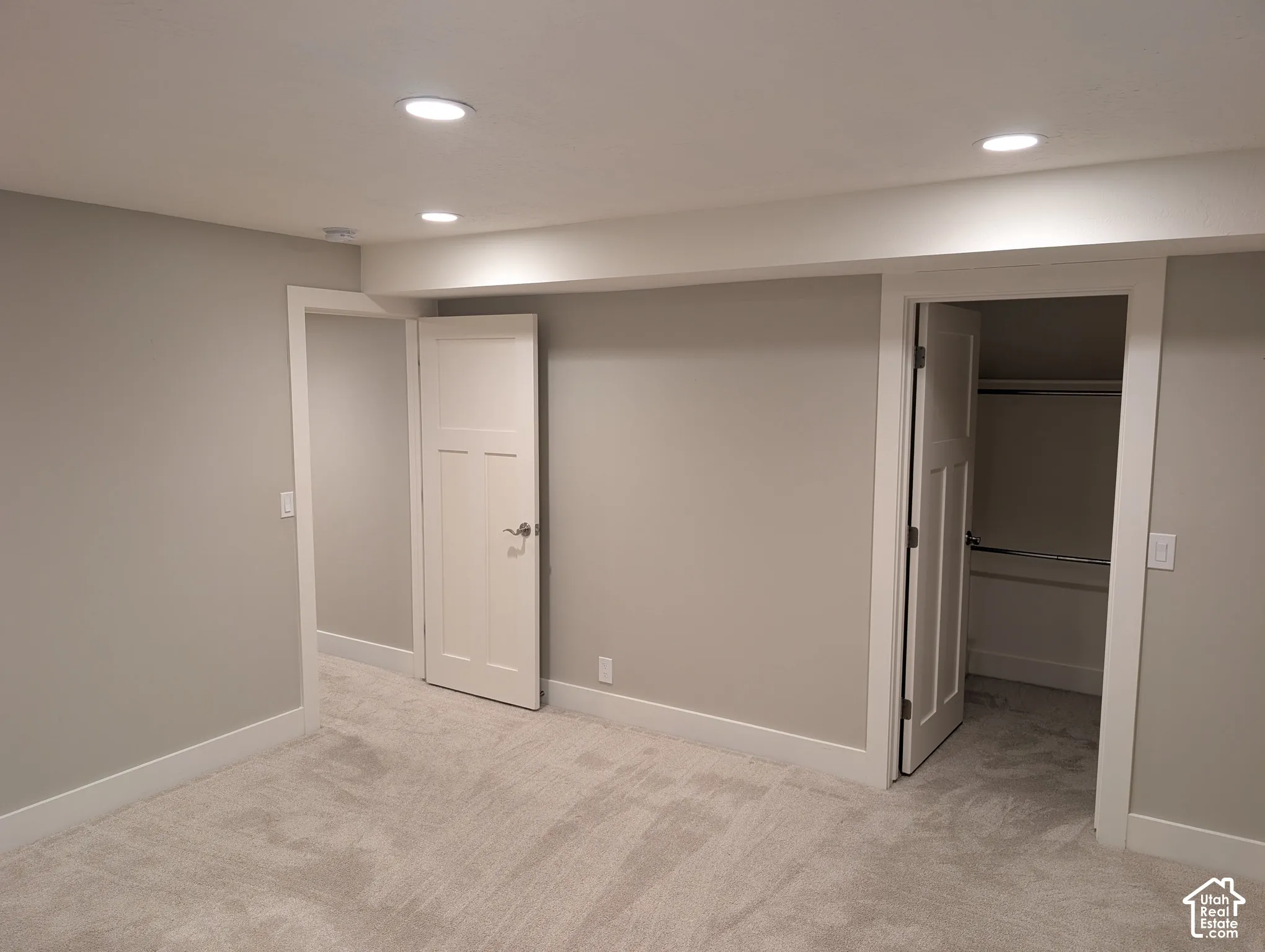 Neutral-toned walls with recessed lighting