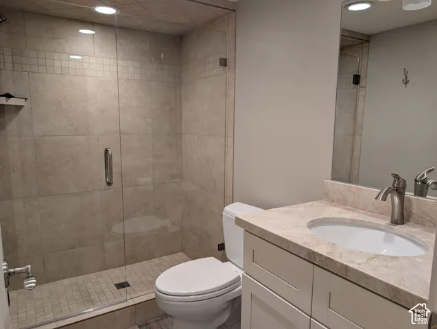 Glass-enclosed shower with tiled walls and floor