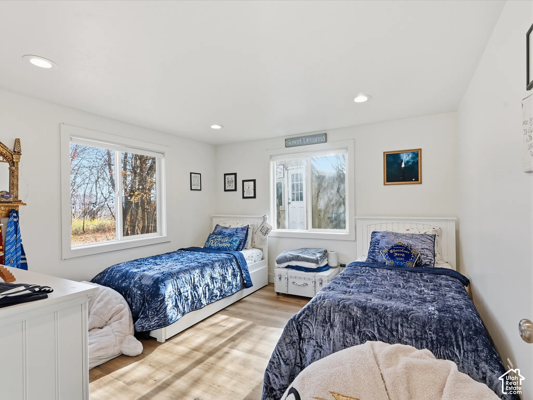 Neutral interior room featuring wood-finish flooring, dual windows, and recessed ceiling lighting
