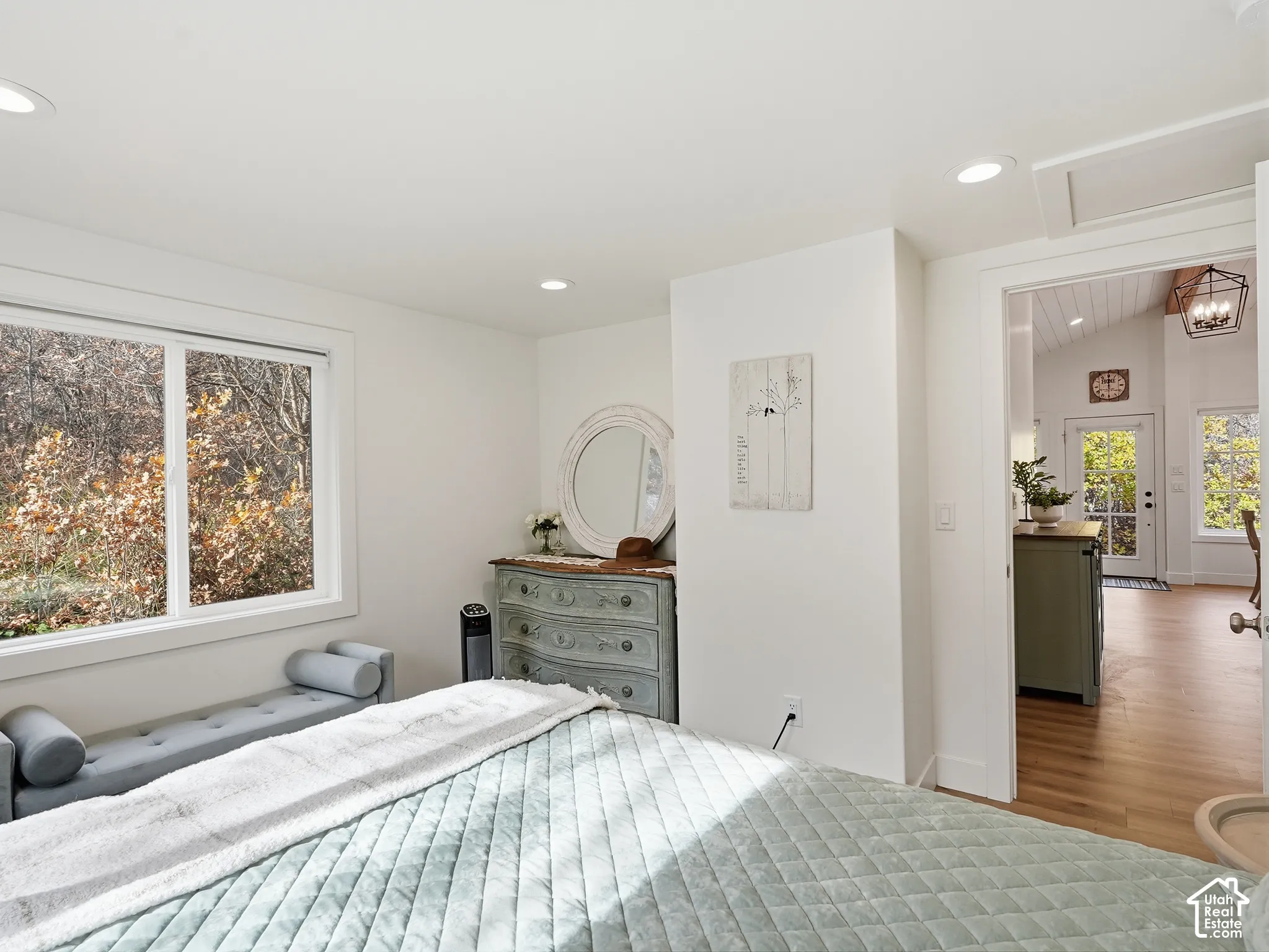 Neutral-toned room featuring recessed lighting, wide-format windows, and wood-finish flooring