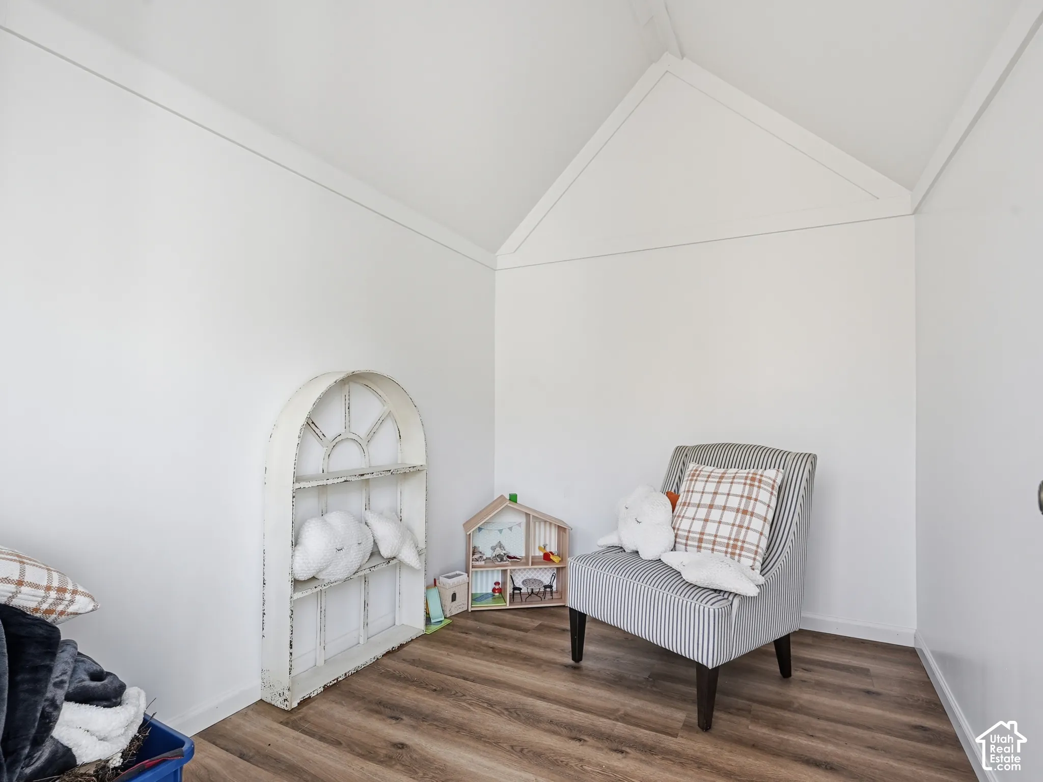 Outbuilding with Vaulted ceiling with clean white interior finishes and durable wood-finish flooring