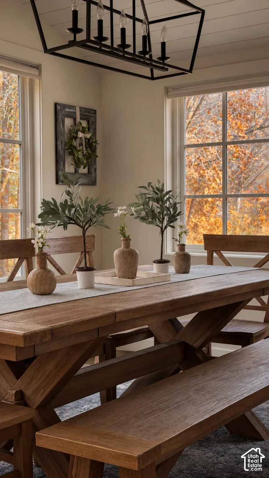 Dining area featuring a matte black geometric lantern pendant light, white plank-style ceiling, and large paneled windows
