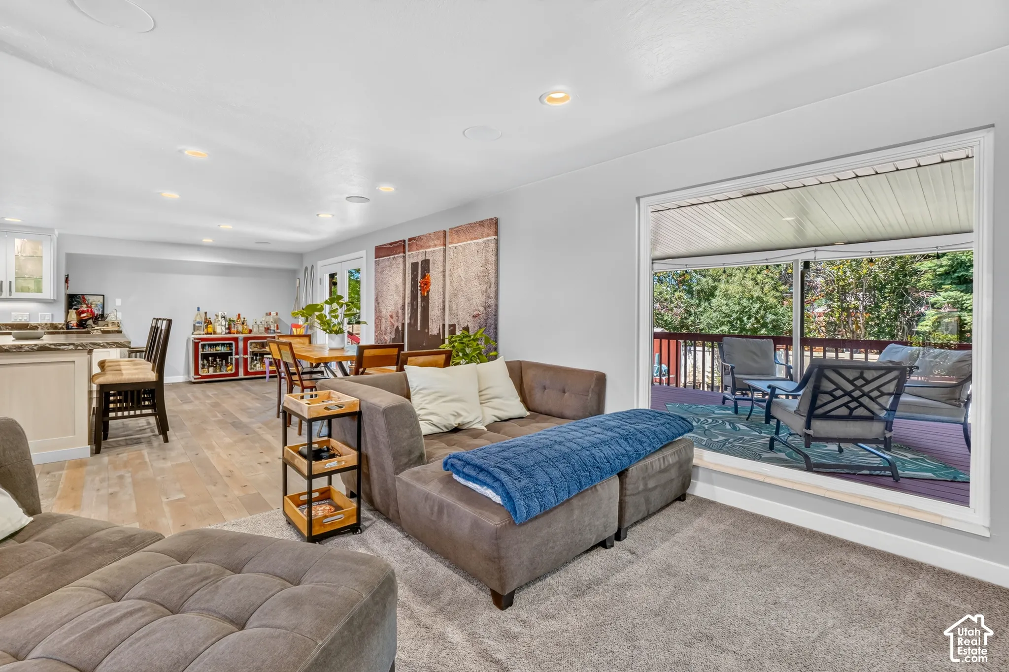 Expansive living area featuring light wood-finish flooring and recessed lighting