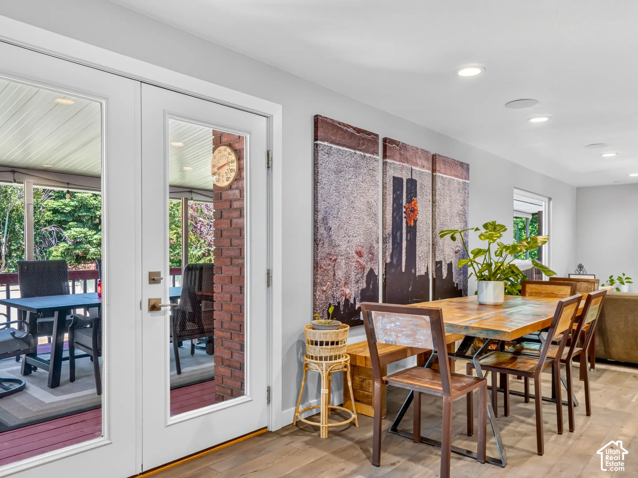 Interior dining area featuring wood-finish flooring, recessed lighting, and white walls