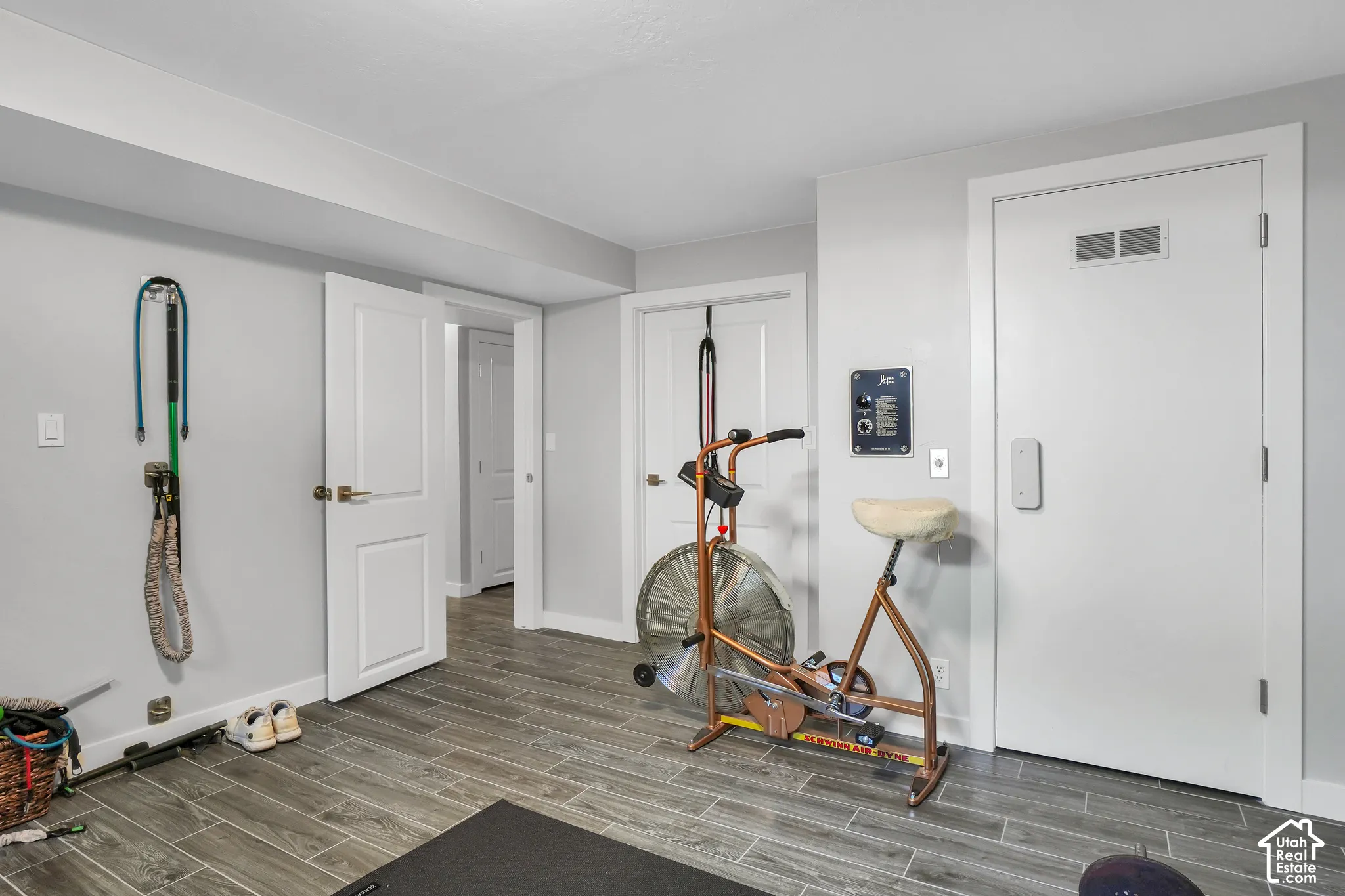 Wood-finish tile flooring, recessed lighting, and crisp white trim