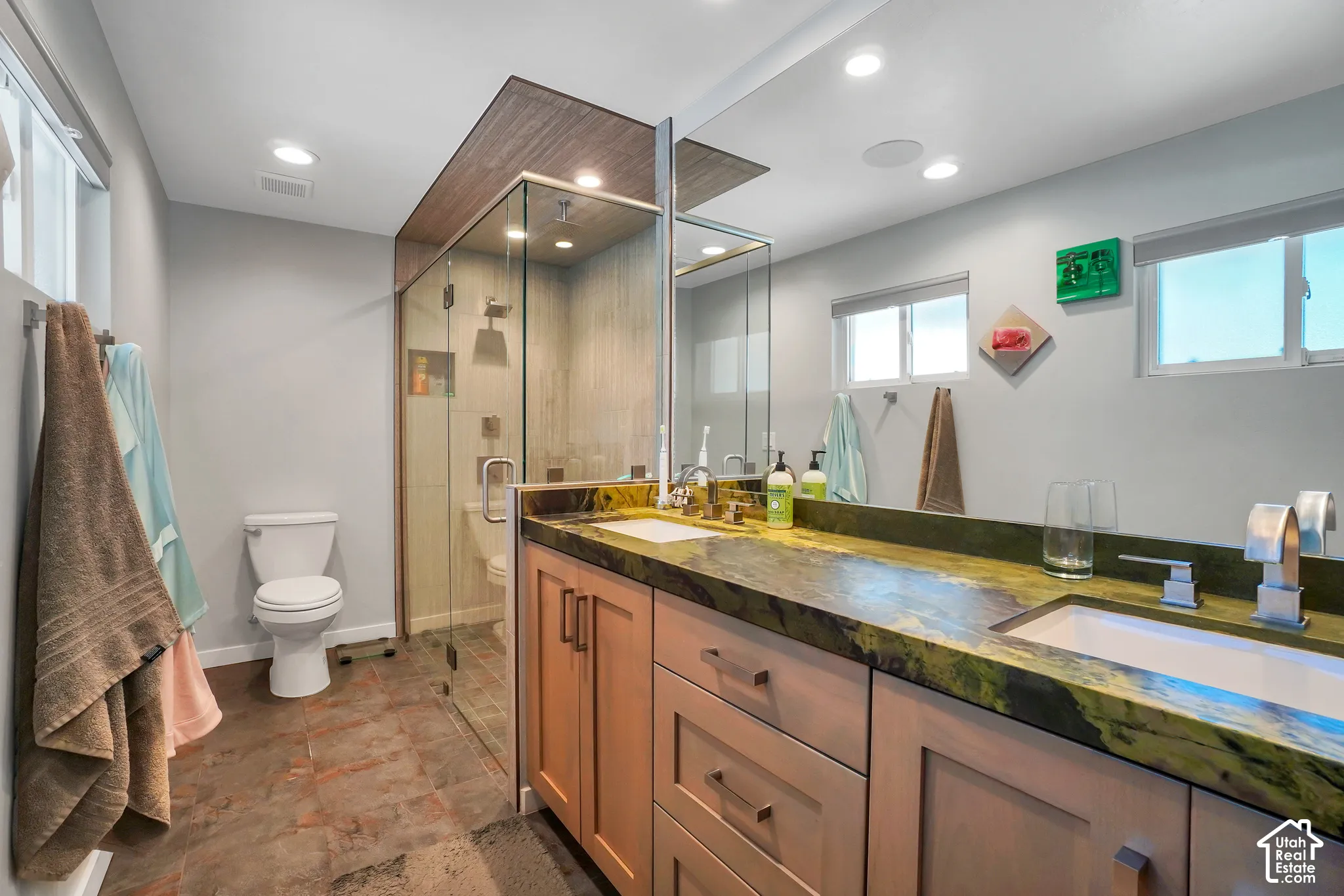 Dual vanity with a stone countertop and integrated sinks