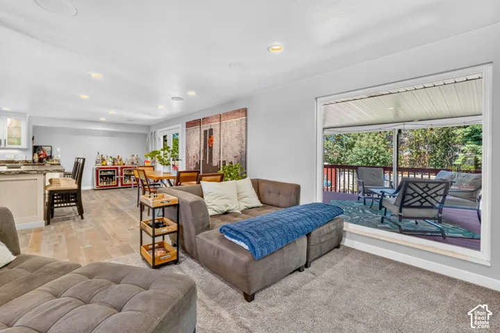 Expansive living area featuring light wood-finish flooring and recessed lighting