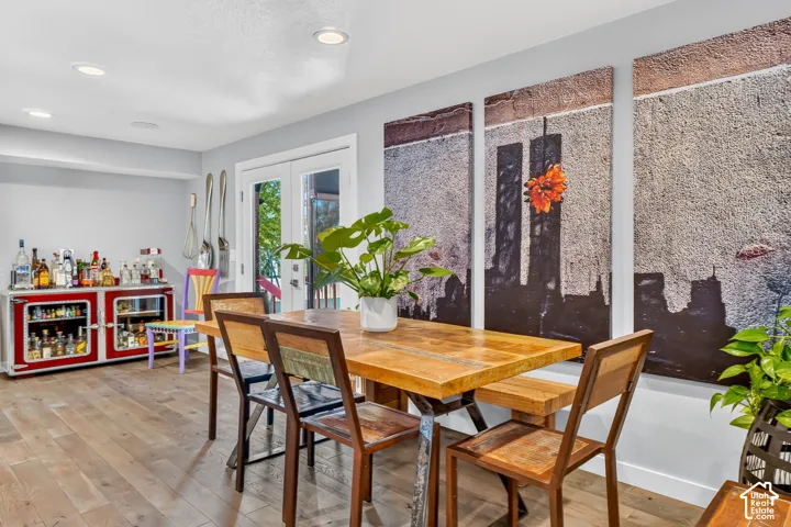 Hardwood-finish flooring, recessed lighting, and double glass-paneled doors