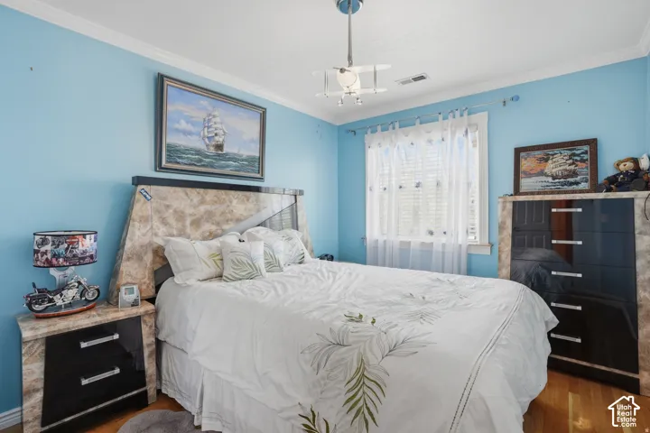 Upstairs 2nd bedroom with solid oak flooring, and crown molding