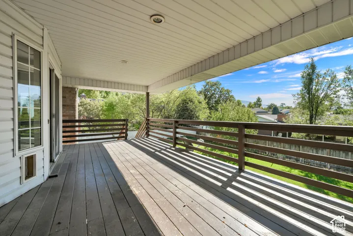 Covered deck featuring wood-finish flooring, horizontal wood railing, recessed ceiling lighting, and siding exterior
