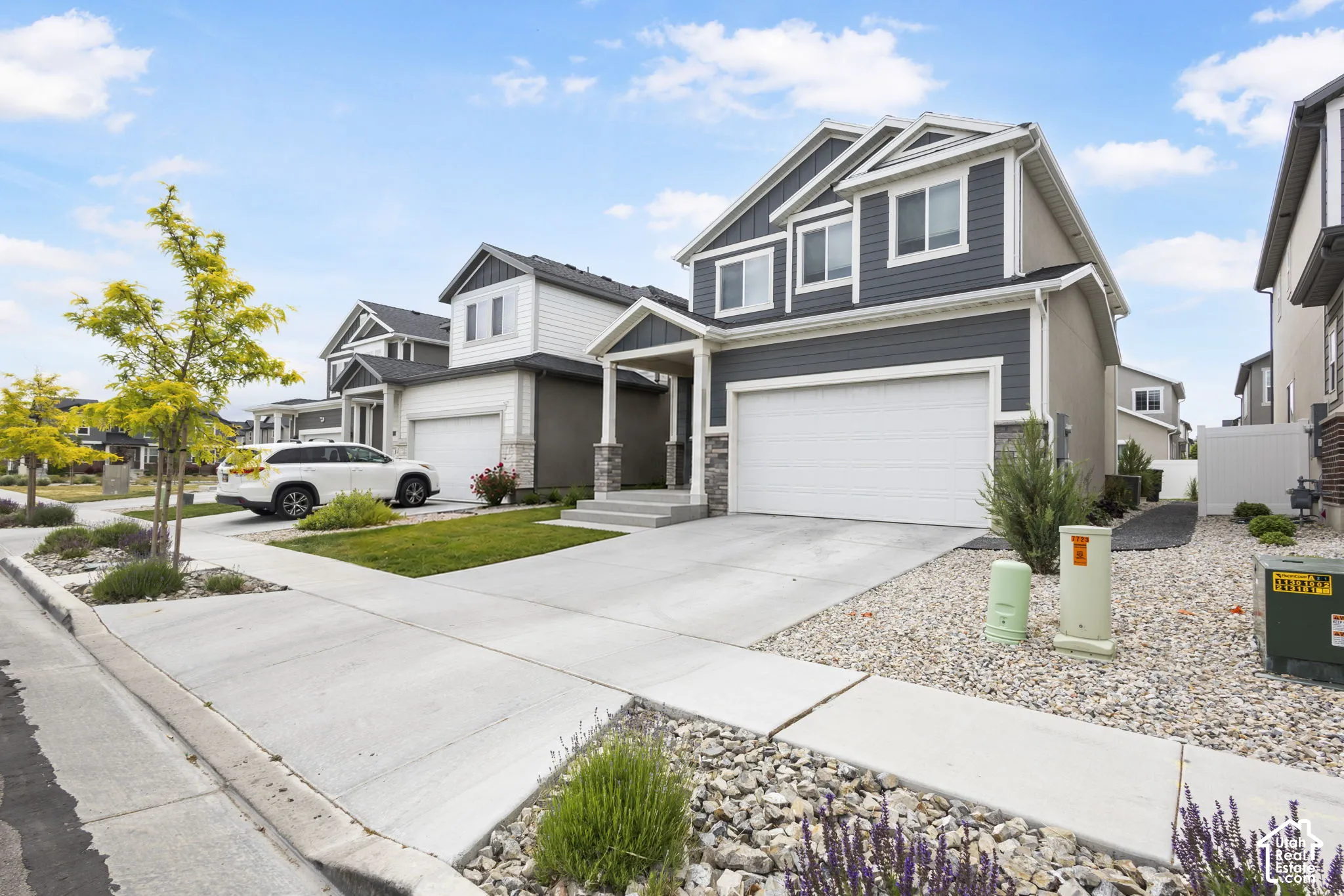 Contemporary two-story exterior with dark gray siding accents and white trim