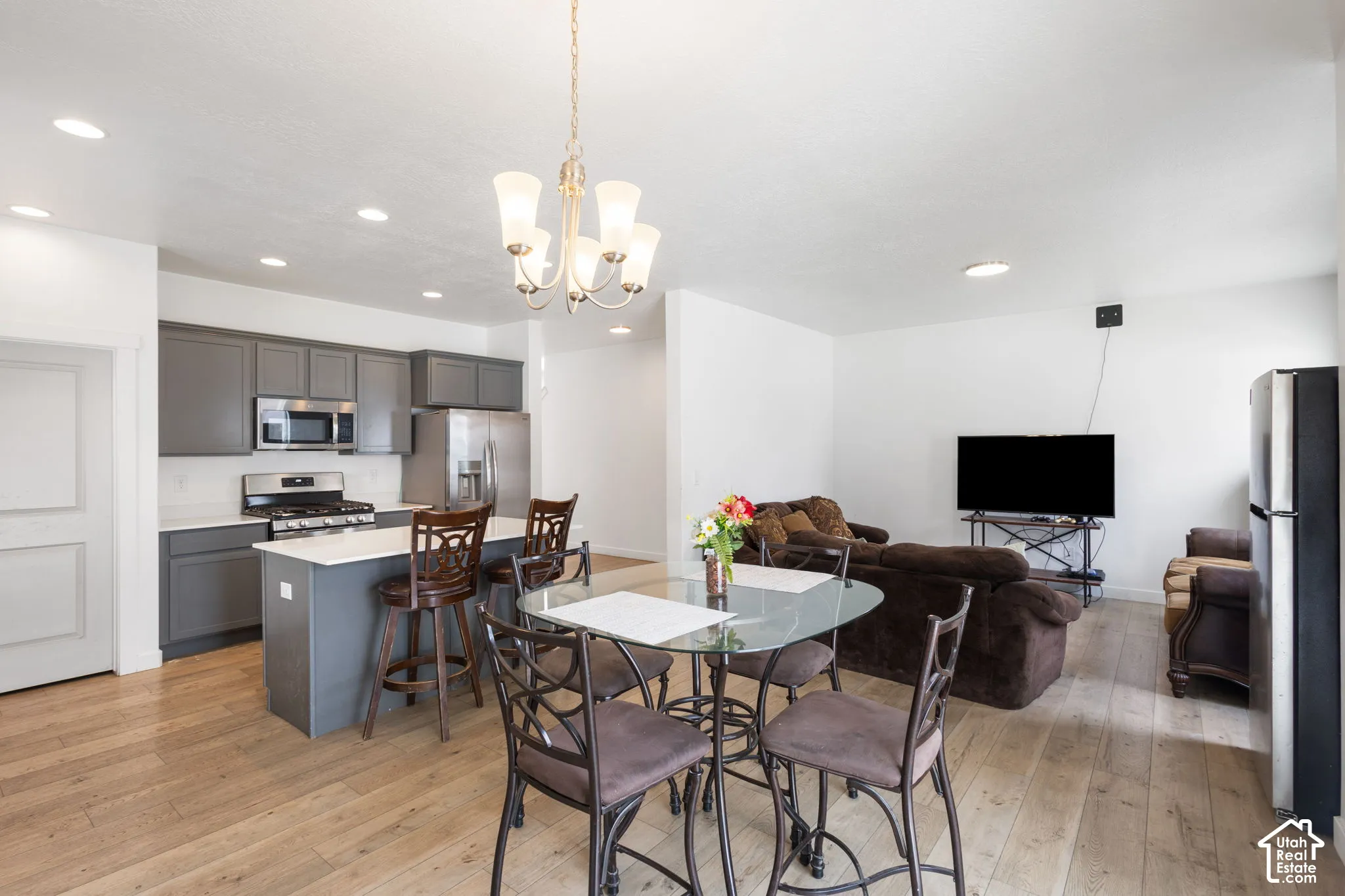 Open-concept living area featuring wood-finish flooring and recessed lighting
