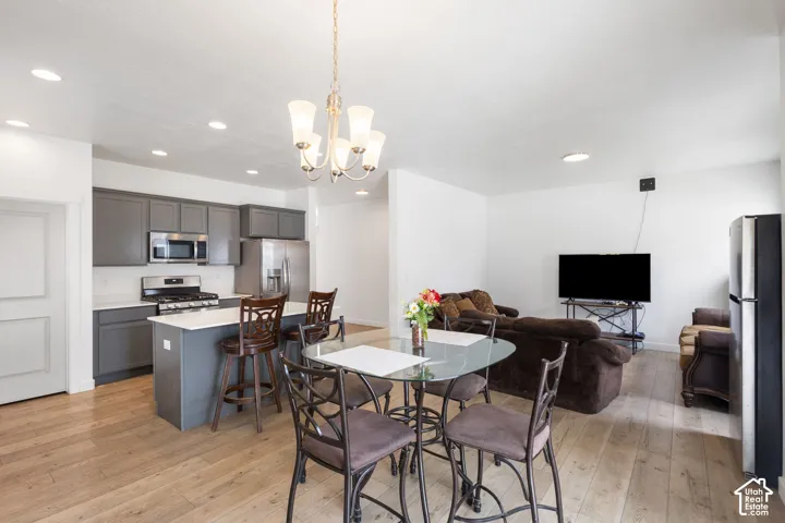 Open-concept living area featuring wood-finish flooring and recessed lighting