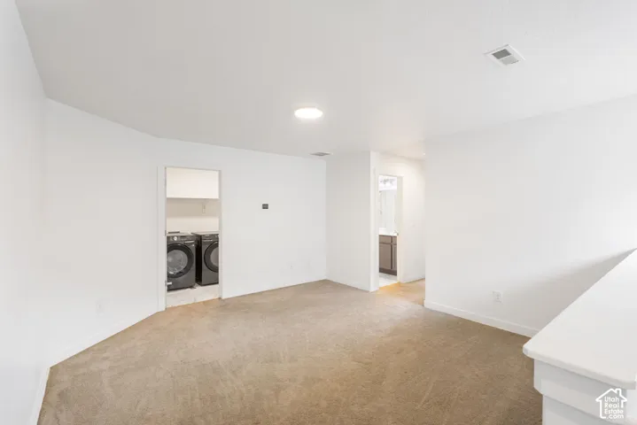White walls with recessed lighting and neutral carpet