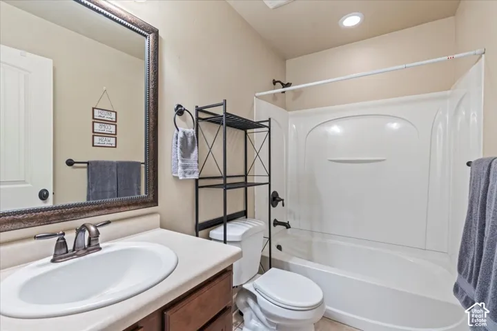 Single vanity with an oval sink, bronze-finish faucet, and a framed mirror