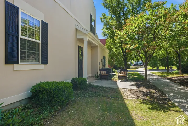 Stucco exterior with black louvered shutters and white window trim