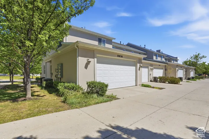 Stucco exterior with multiple garage doors