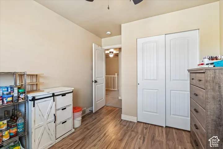 Wood-finish flooring with neutral wall paint and white trim