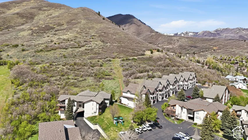 Mountainous terrain surrounding a community of multi-story residences with pitched roofs