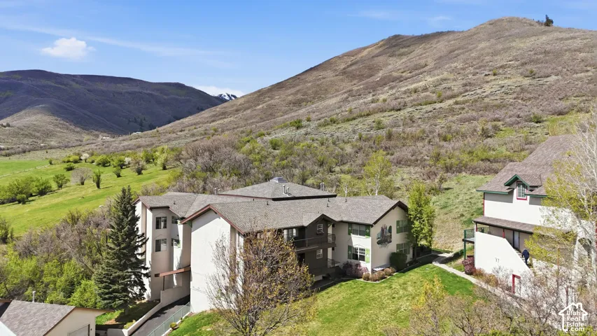 Modern residential architecture set against expansive hillside terrain