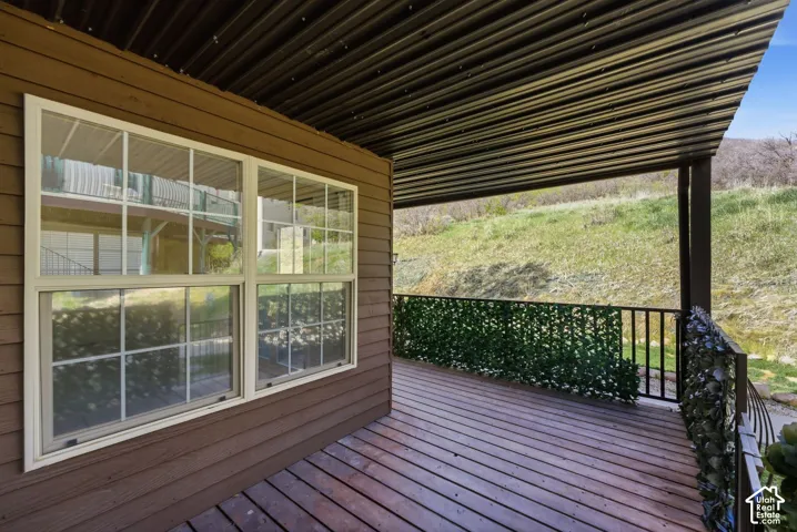 Wood-finish decking with a corrugated metal ceiling and metal railings