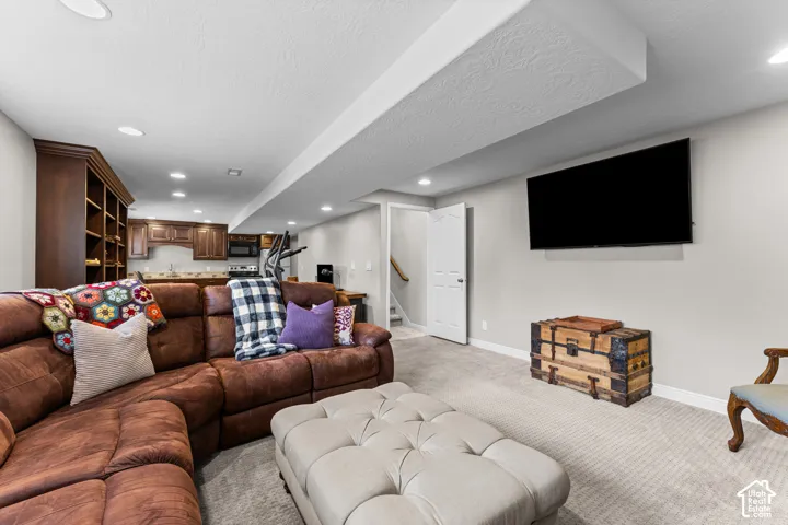 Recessed lighting illuminates the carpeted floor
